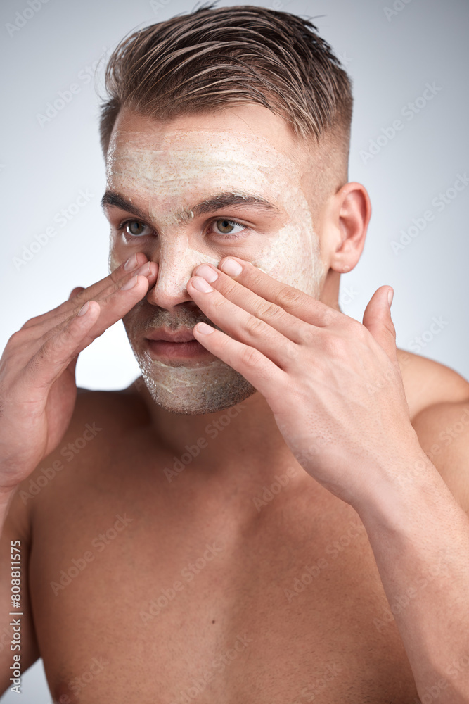 Obraz premium Healthy, man and face mask in studio with cream for dermatology, skincare or treatment on gray background. Male person, cosmetics, with lotion for grooming, wellness routine or facial product