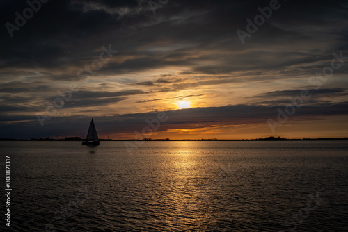 Sailing on The Oosterschelde in Zeeland the Netherlands at sunset © Wirestock