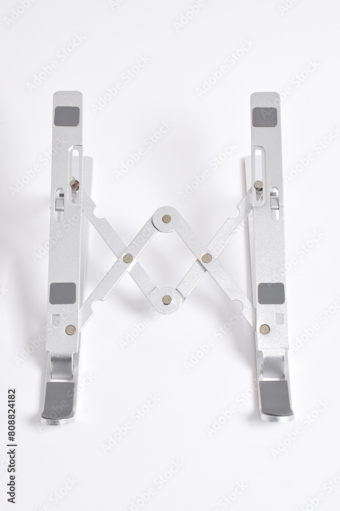 Portable metal laptop stand perspective view isolated on white background. Portable metal laptop stand perspective view isolated on white background.