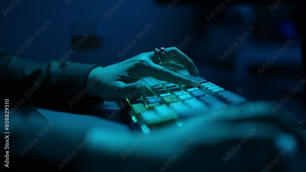 Extreme close-up of unrecognizable female hacker using computer breaks into government data servers and infects their systems with virus. Security password login technology business concept.