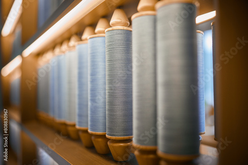 Colourful Thread Spools. Organised shelves filled with gradient thread spools