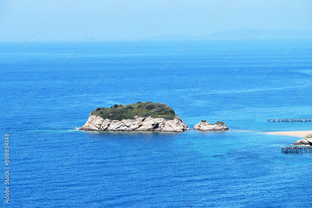 A picturesque isle sits atop the tranquil blue sea, its shores adorned with pristine white sands, inviting exploration and serenity amid nature's tranquil embrace. A picturesque isle sits atop the tranquil blue sea, its shores adorned with pristine white sands, inviting exploration and serenity amid nature's tranquil embrace.