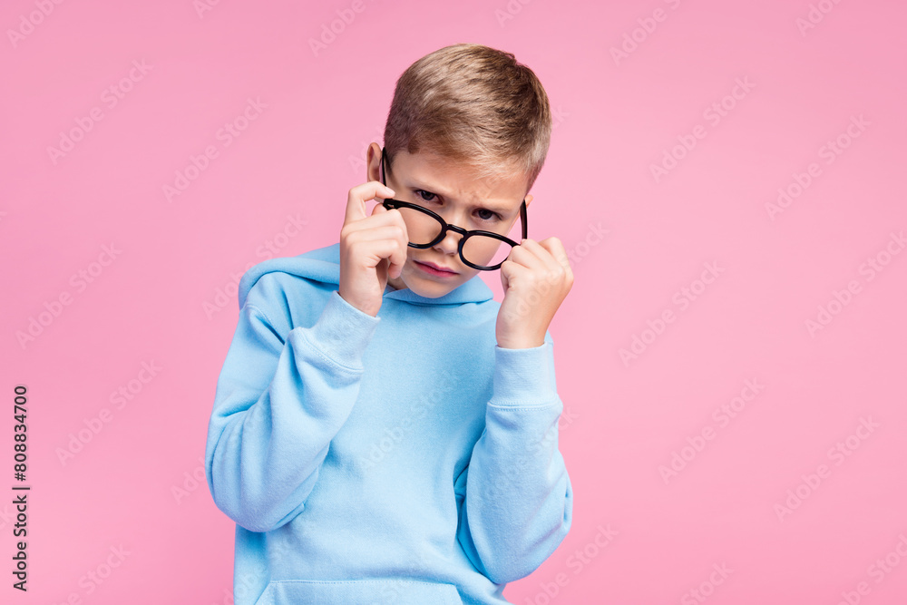 Photo of minded pensive schoolboy hand touch eyewear ponder empty space isolated on pink color background Photo of minded pensive schoolboy hand touch eyewear ponder empty space isolated on pink color background