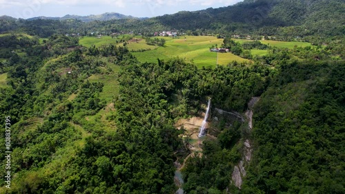 4K Aerial Drone video of epic tall waterfalls falling to rocks in canyon surrounded by jungle, Can-Umantad Falls in Bohol, Philippines photo