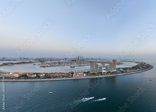 Aerial panoramic view of Palm Jumeirah islands during sunset in Dubai