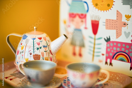 Colorful teapot and cups on table, whimsical design