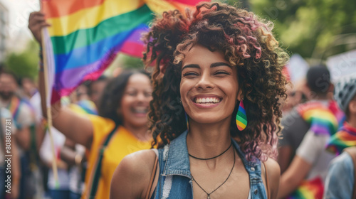 People participate in the pride parade. Multi-ethnic people in the city street with a woman waving gay rainbow flag. Stock Photo photography photo