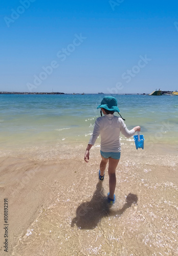 Child playing on the beach on vacation