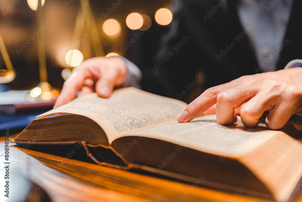 Φωτογραφία A Successful businessmen's hand reading contract or agreement books; Lawyers or attorneys sign approval document; concept of justice; corporate; justice and rights; insurance; court and authority