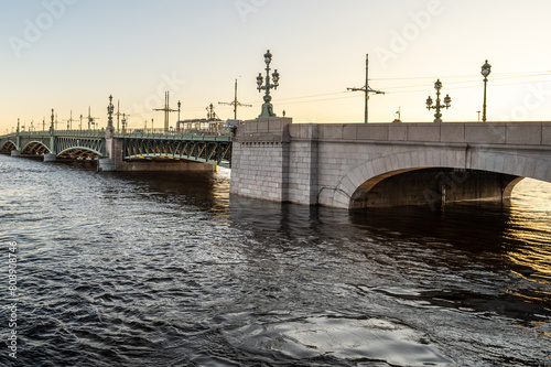 Stone bridge with arches across the Neva River in St. Petersburg.