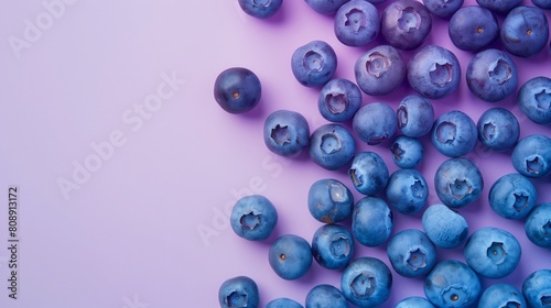 A captivating scene unfolds as a pile of fresh blueberries sits atop a striking purple table, creating a harmonious blend of colors and textures