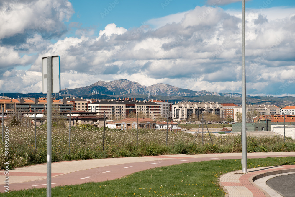 Urban Landscape with Mountain Backdrop and Wind Turbines Urban Landscape with Mountain Backdrop and Wind Turbines