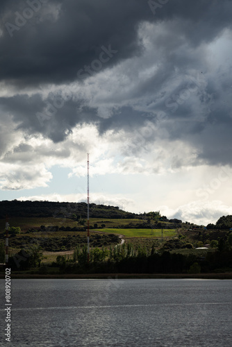 Dramatic Clouds Over Rural Landscape and Lake