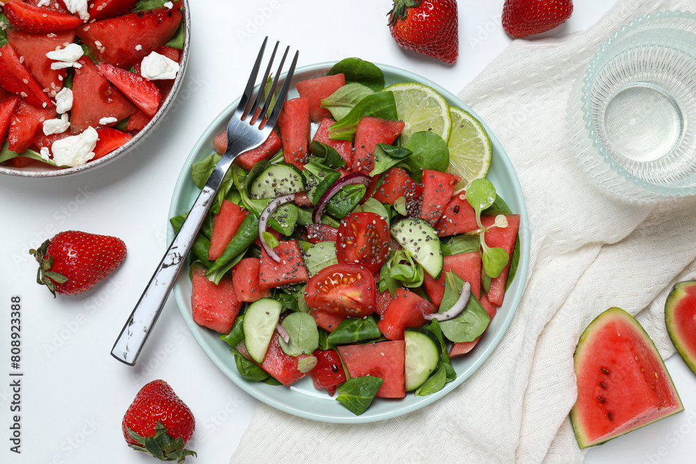 Watermelon salad in a bowl with strawberries and lime Watermelon salad in a bowl with strawberries and lime