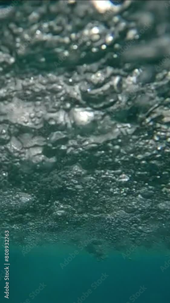Vertical video, Underwater view on rainstorm below water surface, Slow motion. Large drops of heavy rain falling on water, seething surface of water during tropical storm
Vertical video, Underwater view on rainstorm below water surface, Slow motion. Large drops of heavy rain falling on water, seething surface of water during tropical storm