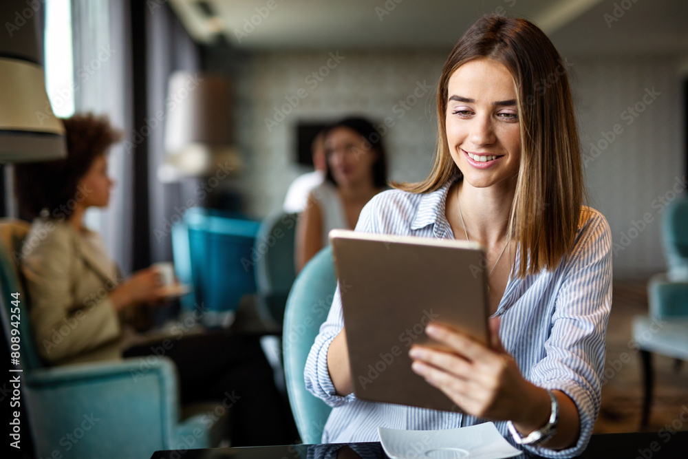 Young happy successful business woman working with tablet in corporate office Young happy successful business woman working with tablet in corporate office
