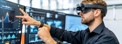 The visionary technophile. A man sporting virtual reality glasses points at a digital screen, immersed in a high-tech world where creativity meets innovation photo