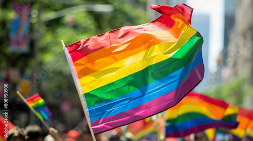 Gay rainbow flag seen during pride parade in the city. Parade goers participate in gay pride march. Stock Photo photography photo