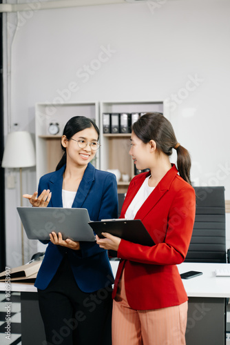 Kind leader executive manager share and discuss business solutions plan ideas on tablet with Asian female marketing manager.