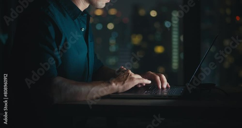 Male person works at computer typing home office close-up on hands programmer writes lines code programming. Person working apartment office programming coding close up to hands night time.