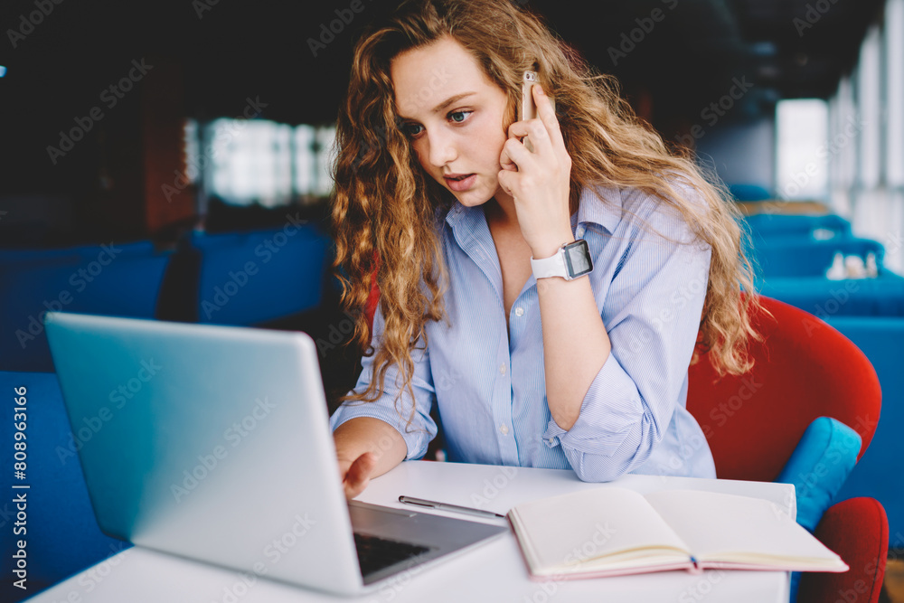 Embarrassed female copywriter feeling confused while thinking about new article for web page working with laptop computer in cafeteria during distance job, hipster girl puzzled on freelance task Embarrassed female copywriter feeling confused while thinking about new article for web page working with laptop computer in cafeteria during distance job, hipster girl puzzled on freelance task