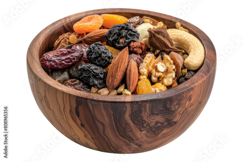 Mix of organic dry fruit in a wooden bowl isolated on transparent background