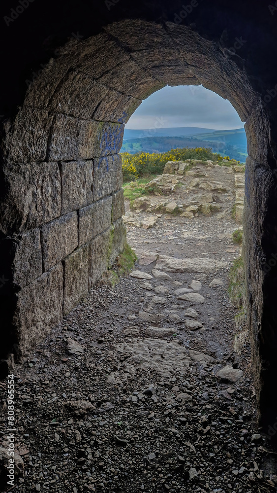 Fototapeta premium The entrance leading into Flue Chimney beckons visitors to step into history's industrial marvels.