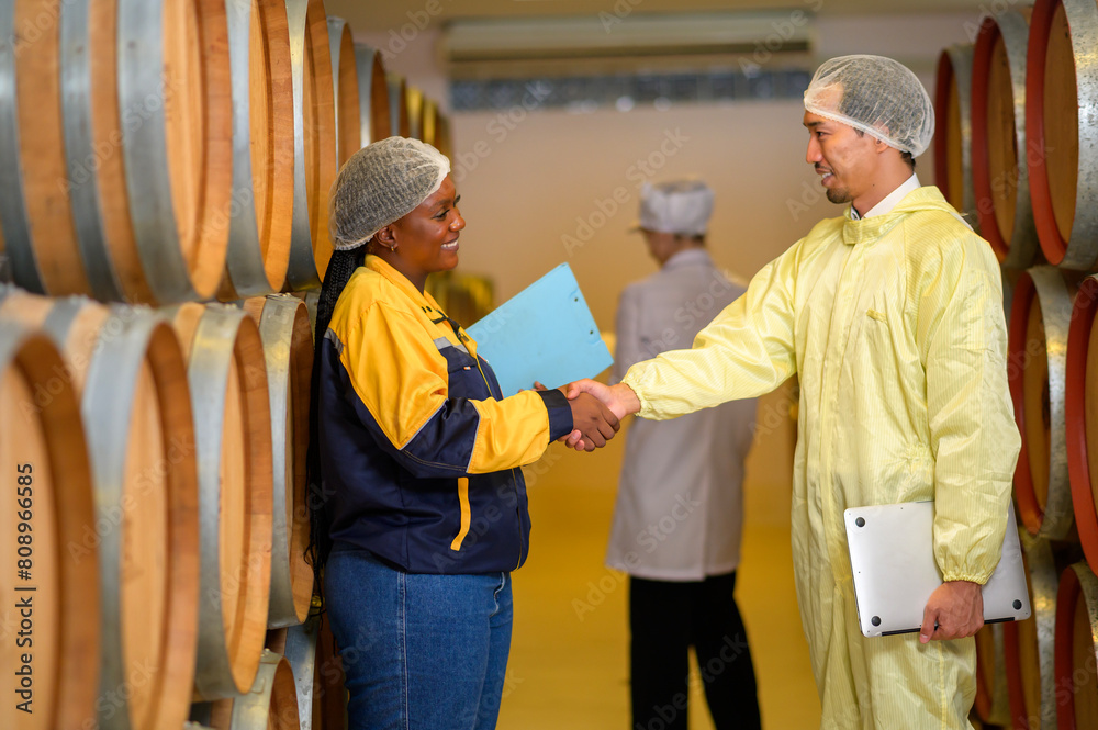 Professional winemaker controlling wine making process and quality at winery factory Professional winemaker controlling wine making process and quality at winery factory