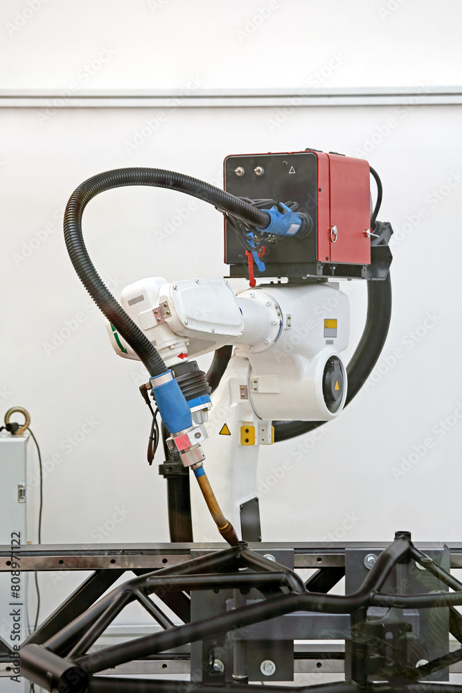 Robot Arm Welding Metal Components in Automated Factory Production Robot Arm Welding Metal Components in Automated Factory Production