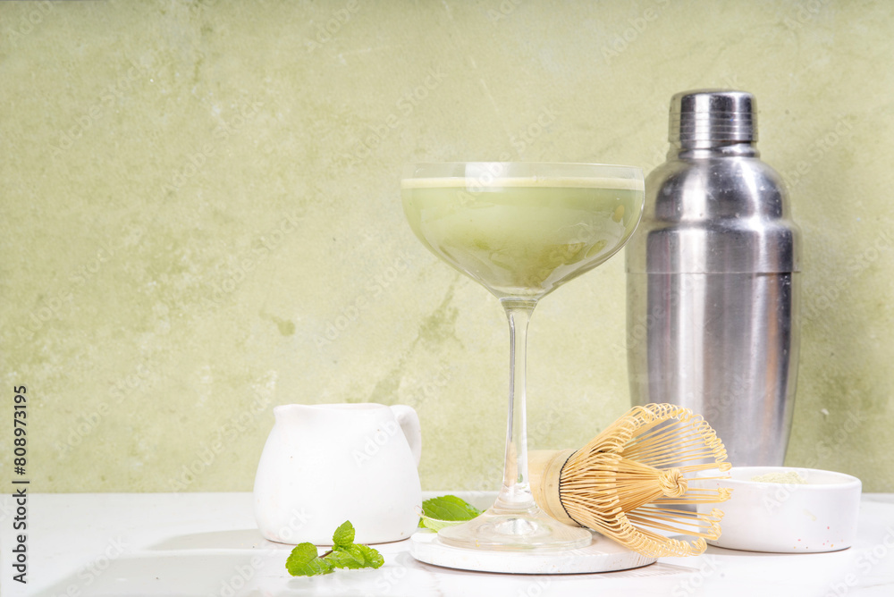 Creamy matcha martini cocktail Matchatini, trendy cold summer cocktail. Matcha non-alcohol mocktail or alcohol cocktail, in martini glasses with green matcha powder, with hard light background Creamy matcha martini cocktail Matchatini, trendy cold summer cocktail. Matcha non-alcohol mocktail or alcohol cocktail, in martini glasses with green matcha powder, with hard light background