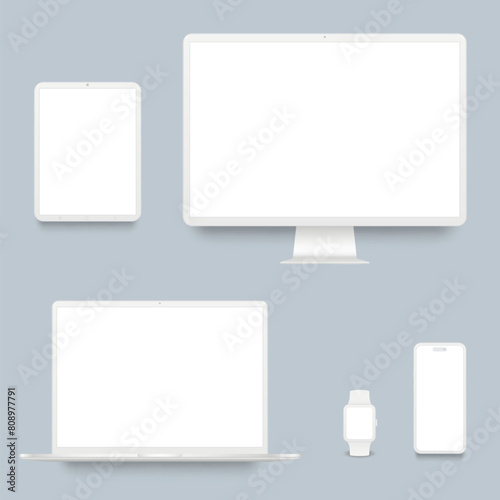 White desktop computer, laptop, smartphone, tablet and smart watch