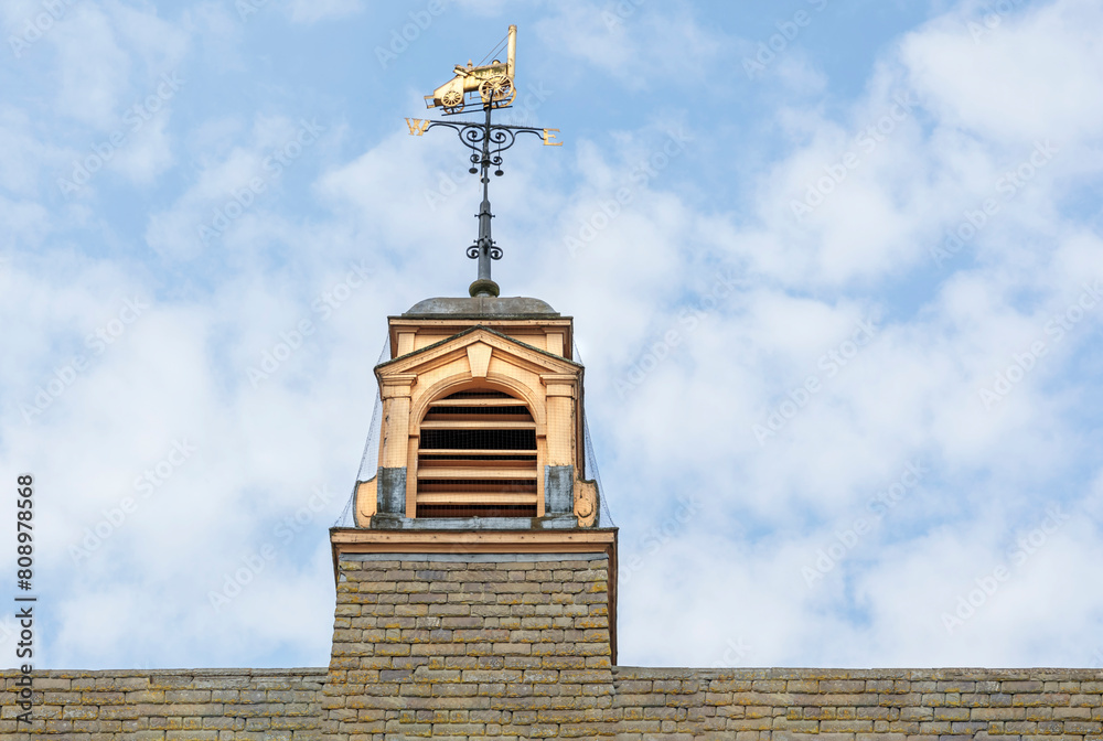 Bellcote on top of a building with a weather vane