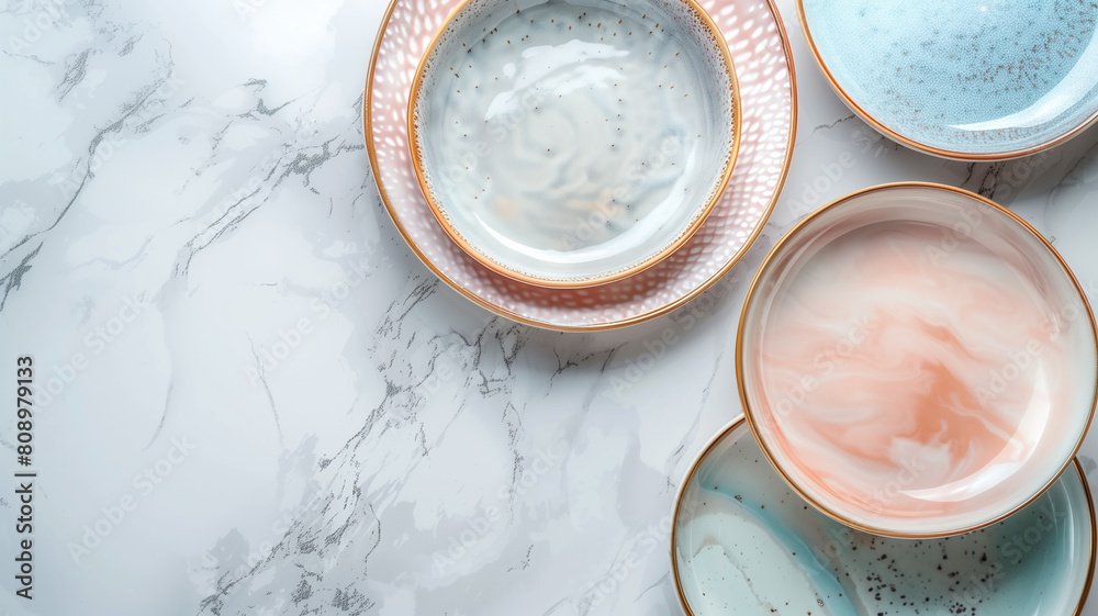 Serving and dining essentials arranged neatly: pastel-hued plates atop a sleek grey marble surface, viewed from above. Contemporary ceramic dishware, stylish and chic. Serving and dining essentials arranged neatly: pastel-hued plates atop a sleek grey marble surface, viewed from above. Contemporary ceramic dishware, stylish and chic.
