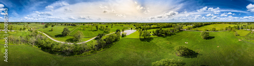 Aerial panorama showcasing fields, trees, and pastures on horse farms in central Kentucky.