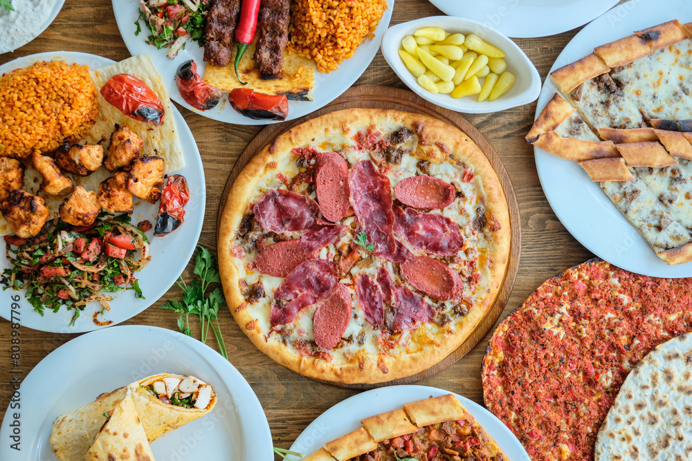 Top View photo: A collection of various dishes: grilled meat pizza Top View photo: A collection of various dishes: grilled meat pizza