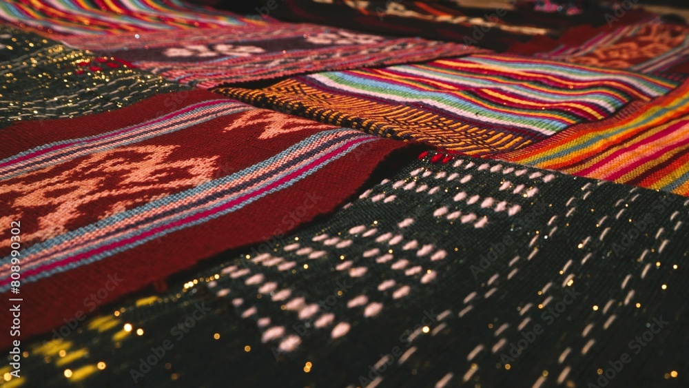 Close up side view handmade woven fabric with unique pattern from Indonesia, selective focus, multicolour textured textile background Close up side view handmade woven fabric with unique pattern from Indonesia, selective focus, multicolour textured textile background