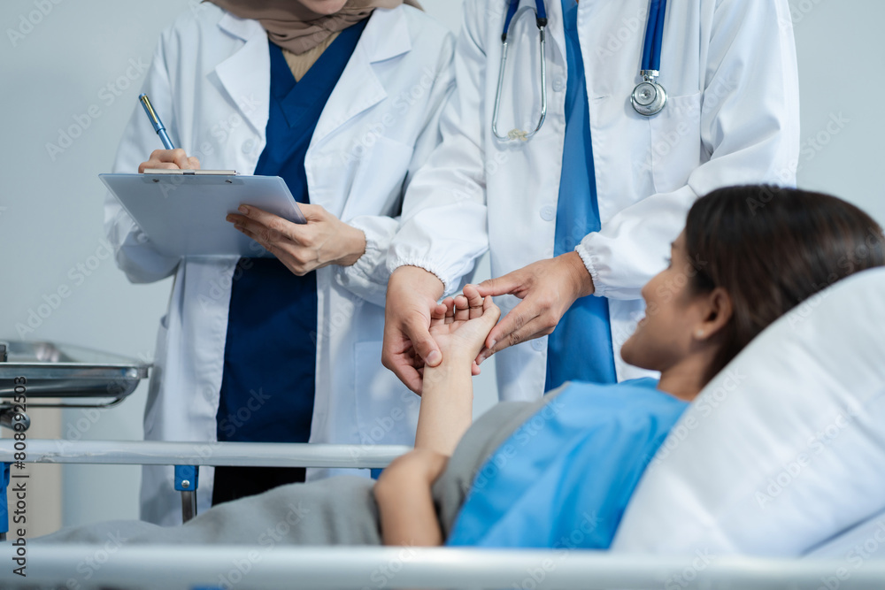 doctor talking with woman patient for monitoring and check up after surgery. doctor touching patient hand and consoling. doctor talking with woman patient for monitoring and check up after surgery. doctor touching patient hand and consoling.