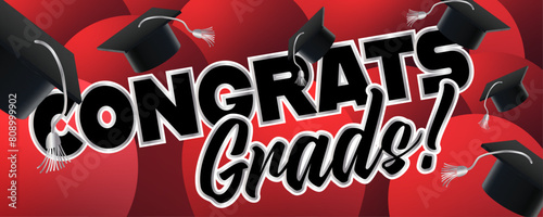 Black, Silver, and Red Graduation Sign. Very joyful graduation caps are tossed with red balloons in the background.