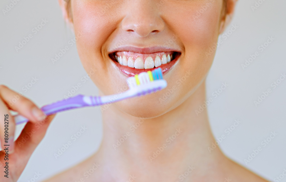 Dental, toothbrush and woman brushing teeth in bathroom for oral care, hygiene or fresh breath on white background. Tooth, cleaning or girl with toothpaste, product or routine for bacteria prevention Dental, toothbrush and woman brushing teeth in bathroom for oral care, hygiene or fresh breath on white background. Tooth, cleaning or girl with toothpaste, product or routine for bacteria prevention
