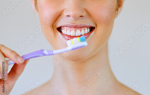 Dental, toothbrush and woman brushing teeth in bathroom for oral care, hygiene or fresh breath on white background. Tooth, cleaning or girl with toothpaste, product or routine for bacteria prevention