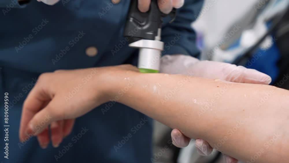 Close up video of professional cosmetologist doing laser hair removal of hand to young woman in beauty salon, Body care epilation treatment. Close up video of professional cosmetologist doing laser hair removal of hand to young woman in beauty salon, Body care epilation treatment.