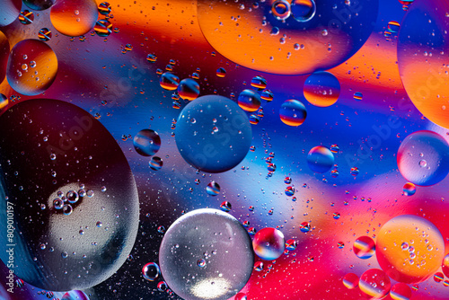 Colorful oil drops floating on the water. holiday postcard background.