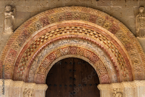 Romanesque archivolts of a church with relief and red painted  photo