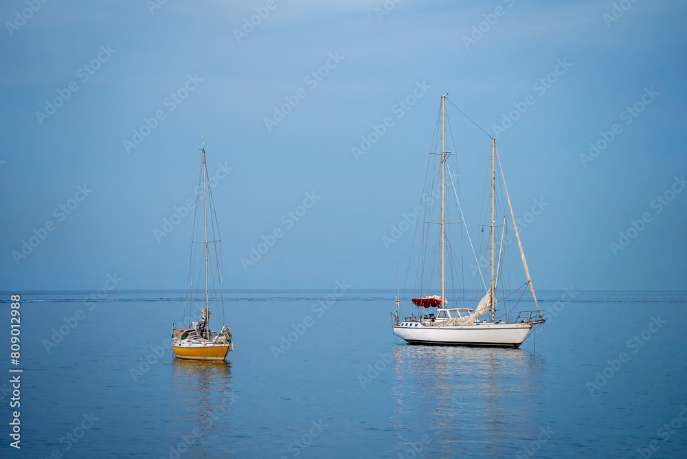Two yachts in the blue sea.