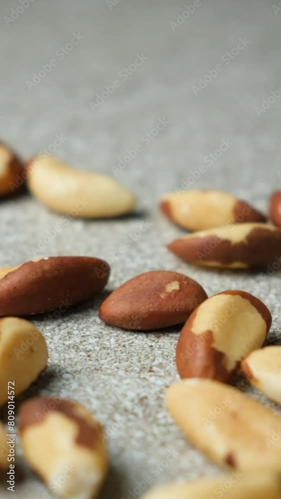 Close-up of falling Brazil nuts on grey background. Close-up of falling Brazil nuts on grey background.