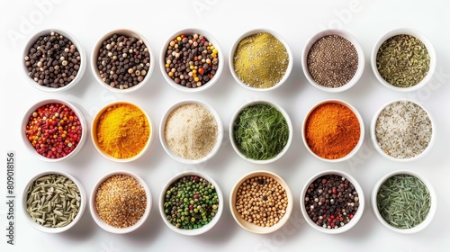 Top view of a colorful collection of spices, arranged neatly in small containers, isolated on a white background under studio lighting