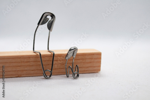 Model safety pin of mother or farther comforting his of her son. Family concept