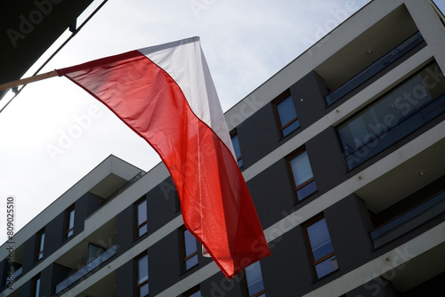 Polish flag and multistorey residential building on 3rd of May Constitution Day