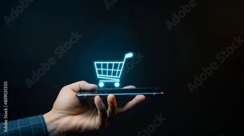 A person holding a glowing shopping cart icon on virtual screen