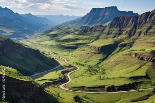 Lesotho landscape. Breathtaking Green Valley with Serpentine Road and Mountain Ranges.